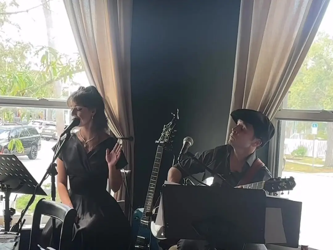 The Western Gypsies, a singer and guitarist, playing by the café windows